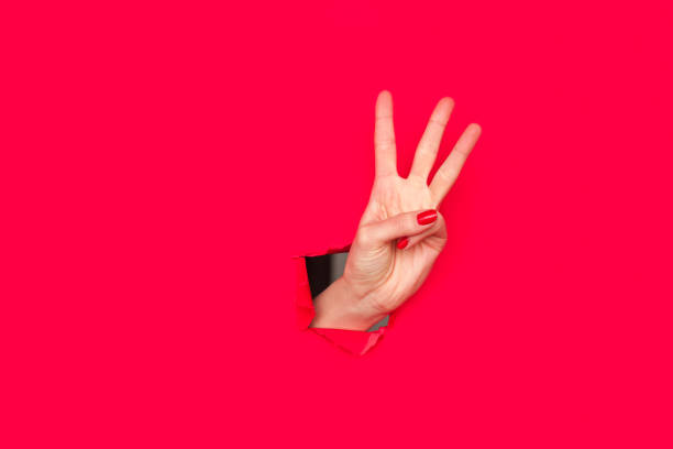 istock Female hand showing three fingers 804420326