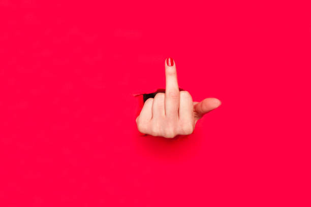 istock Woman showing middle finger in hole 804420344