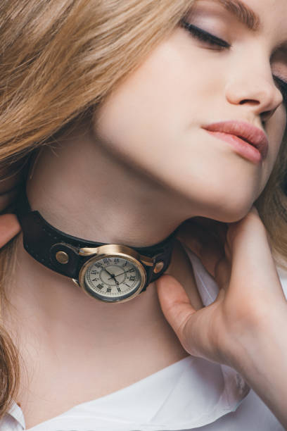 istock girl fitting vintage watch on neck 804422958