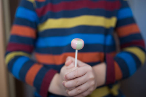 istock Lollipop in child hand 804422978