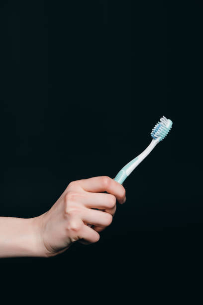 istock female hand holding tooth brush 804423824