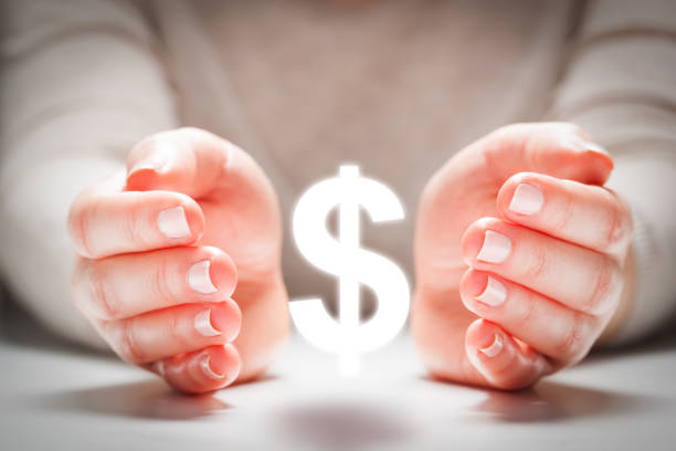 Dollar sign between woman&#39;s hands in gesture of protection. Currency stability Dollar sign between woman&#39;s hands in gesture of protection. Concept of currency rate stability, finance. financial wellbeing stock pictures, royalty-free photos & images