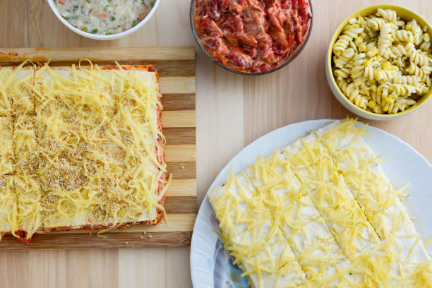 Colorful salads in ceramic bowls and salt cake with cheese and red paprika