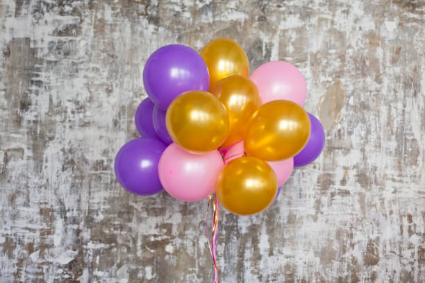 istock Bright balloons bunch against a textured wall 804435360