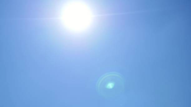 istock Rainbow kite flies in the blue sky against sunshine 804439134