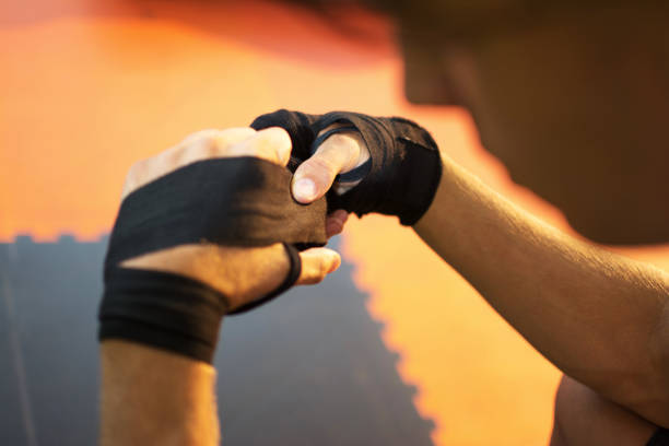 istock Unrecognizable man putting on sport gloves in gym. 804449282