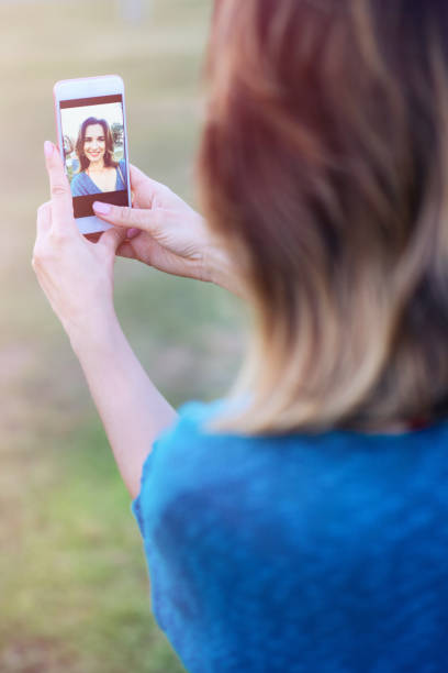 istock Young woman taking selfie in the park 804458634