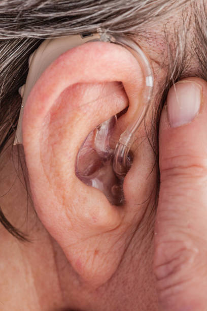 istock Closeup senior woman using hearing aid 804459074