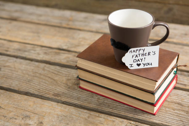 istock Greetings with coffee cup on stack of books at table 804465454