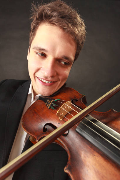 istock Man playing violin showing emotions and expressions 804482164