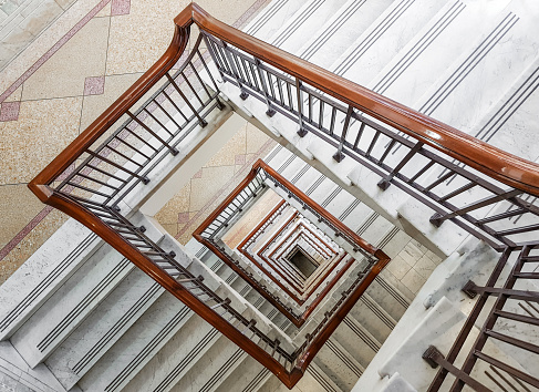 This large staircase made of marble winds down through many levels in an inner city office