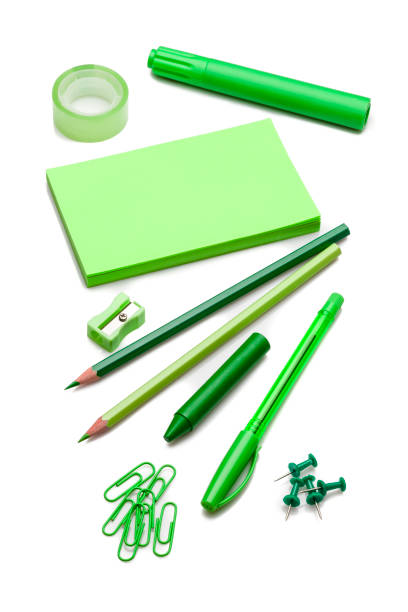 istock Green colored office or school supplies on white background 804487408