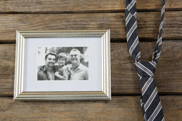 istock Overhead view of picture frame by necktie on table 804490698