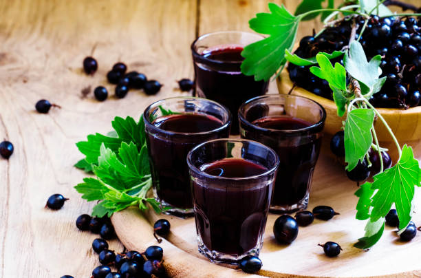 Black currant juice in glass, selective focus Black currant juice in glass, selective focus casis stock pictures, royalty-free photos & images