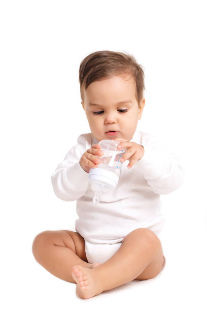 istock Sweet baby holding bottle and drinking water 804497904