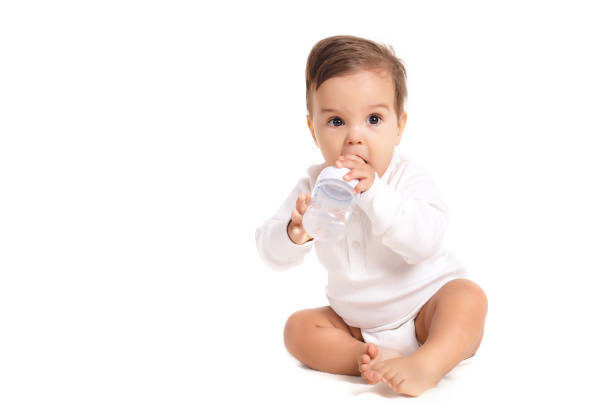 istock Sweet baby holding bottle and drinking water 804497936