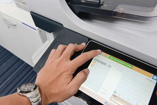 Human hand is using the printer