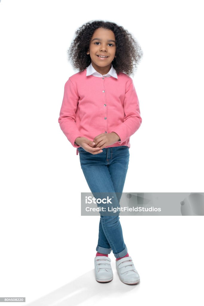 little smiling african american girl posing in pink cardigan isolated on white Girls Stock Photo