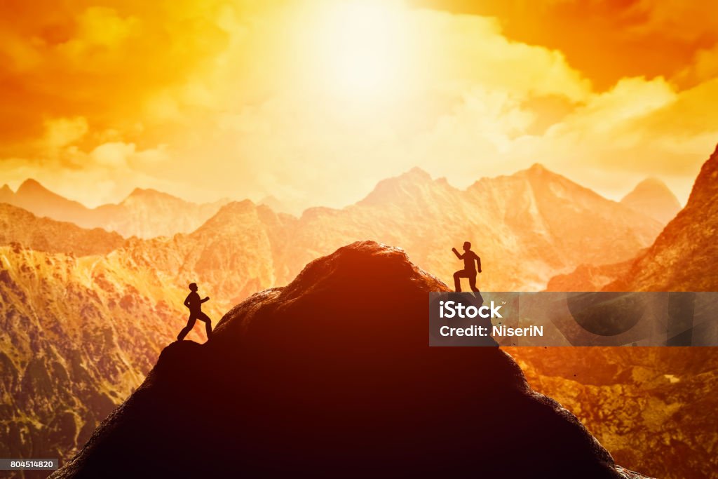 Two men running race to the top of the mountain. Competition, rivals, challenge Two men running race to the top of the mountain. Competition, rivals, challenge in life concepts Occupation Stock Photo