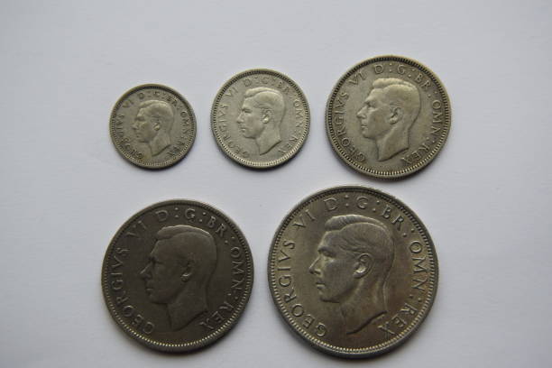 Selection of George VI silver coins Image of the reverse side of a selection of silver British coins including 3d, 6d, shilling, florin and half-crown george vi stock pictures, royalty-free photos & images