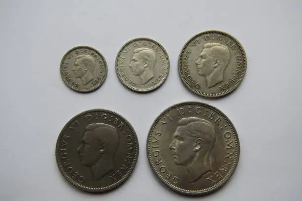 Image of the reverse side of a selection of silver British coins including 3d, 6d, shilling, florin and half-crown