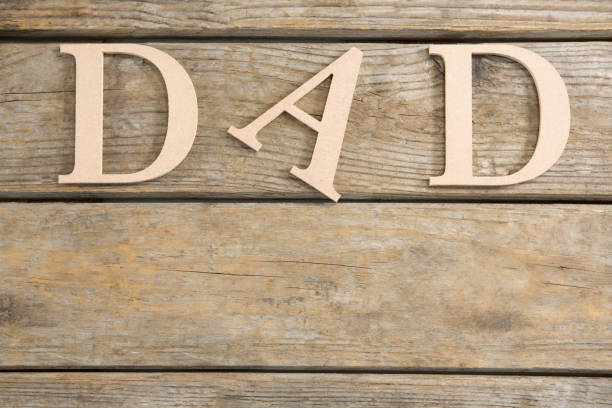 istock Overhead view of beige dad text on table 804529788