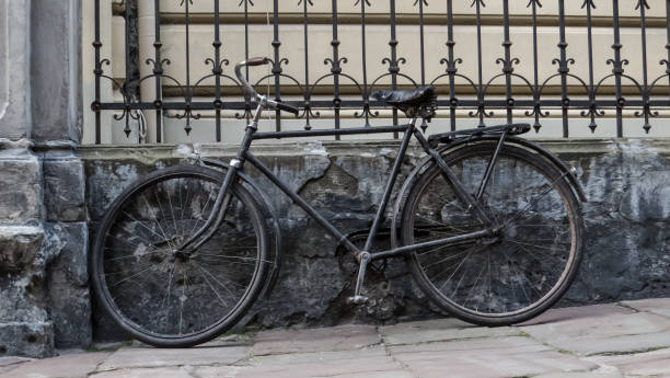 istock Old bicycle parked against fence and an old house 804532338