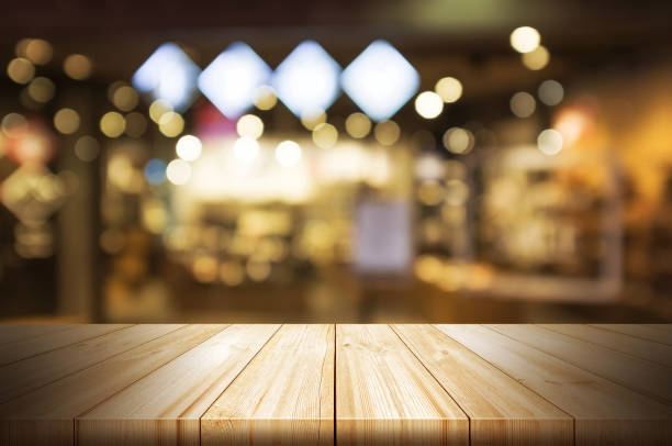 istock Empty wooden table top with blurred restaurant or cafe light background. can be used product display. 804550924