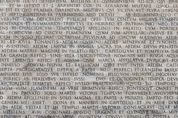Photo of Texture of latin words engraved on a marble plaque