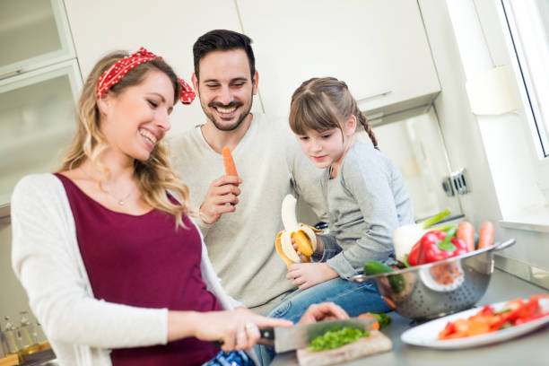 istock Happy young family in kitchen 804592418