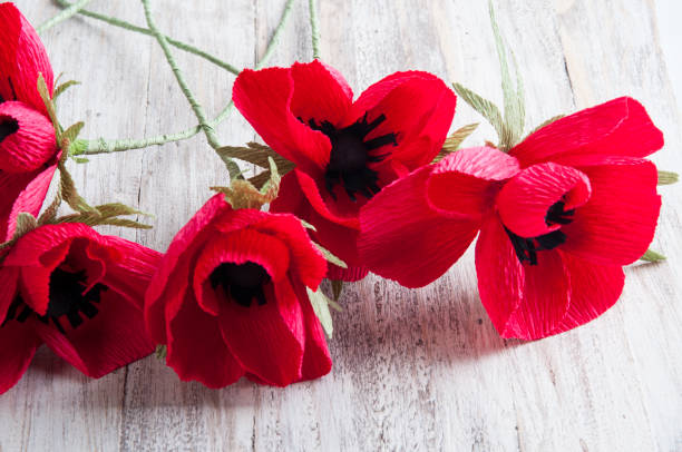 PAPER FLORAL ART. decorative hand made paper flowers on wooden background