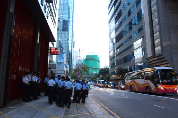 Policemen gather on Harbour Road, Wanchai, Hong Kong Island, on the first day of President Xi Jinping's visit On the first day of President Xi Jinping's visit to Hong Kong for the 20th anniversary of the handover of Hong Kong to China, a heavy police presence was seen in Wan Chai. This is Harbour Road. xi jinping stock pictures, royalty-free photos & images