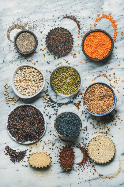 istock Variety of raw grains, beans, cereals over grey marble background 804595366