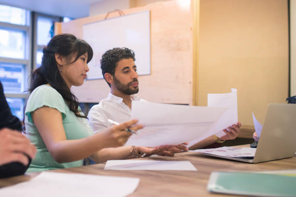 istock Multi-ethnic group of business people reviewing documents 804595932