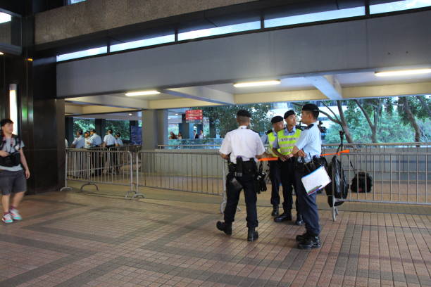 Police officers guard the area while within the Harbour Centre in Wan Chai, close to where President Xi Jinping is active on his official visit to Hong Kong There was heavy police presence in the Wan Chai locality of Hong Kong due to the Chinese President Xi Jinping being in the area, on the first day of him being in Hong Kong for the trip. While many police vehicles and police officers conduct security operations at ground level, many police officers of various ranks are seen working from height to guard the area, as seen in this photo. xi jinping stock pictures, royalty-free photos & images