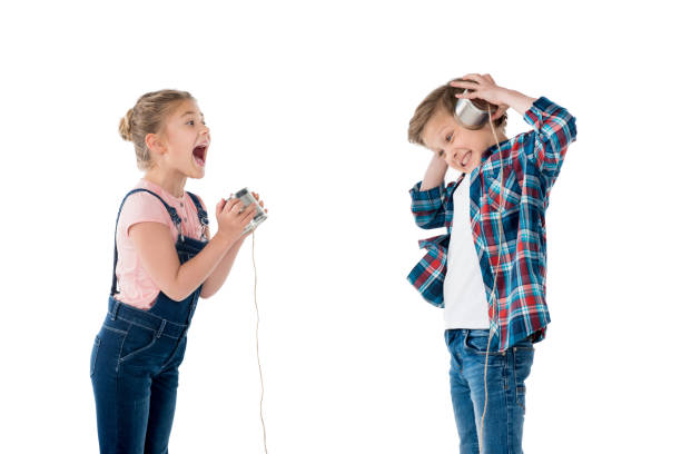istock children using metal cups as telephone while playing together isolated on white 804600934