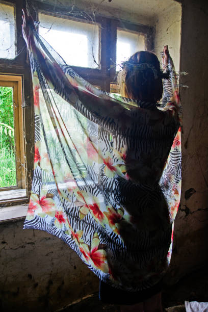 istock Young girl in front of an old window 804601014