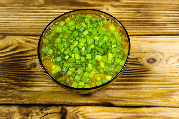 istock Fresh vegetable soup in glass bowl on wooden table. Top view 804601236
