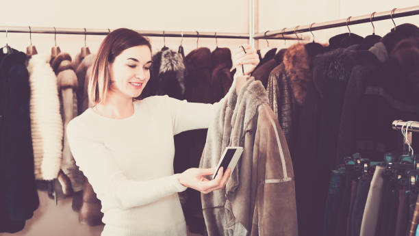 istock Nice female customer examining sheepskin coat 804607824