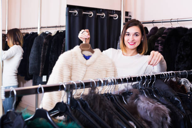 istock Girl choosing mink jacket 804608100