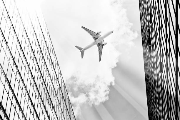 istock Airplane flying over business skyscrapers 804608190