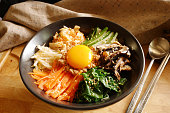 traditional korean food,bibimbap ,korean rice mixed with meat and vegetables and egg yolk on top