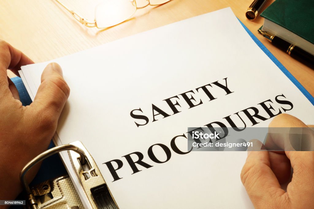 Safety procedures in a blue folder. Work Safety concept. Safety Stock Photo