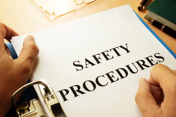 Photo of Safety procedures in a blue folder. Work Safety concept.