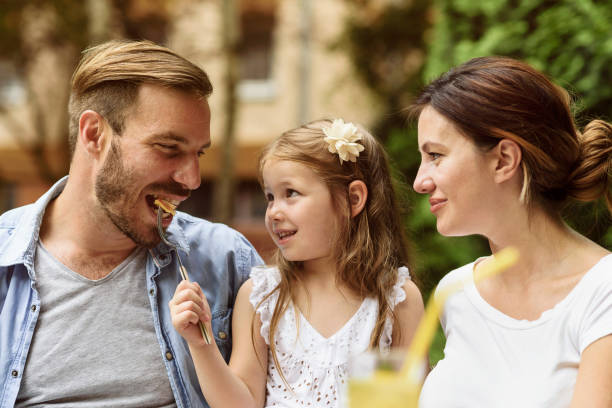 istock Happy child enjoying meal with parents 804619236