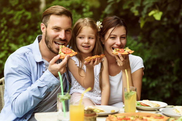 istock Happy family eating in a restaurant 804619578