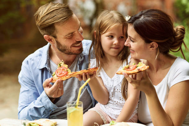istock Happy family eating in a restaurant 804619584