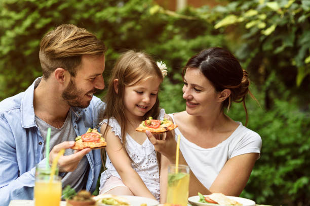 istock Happy family eating in a restaurant 804619692