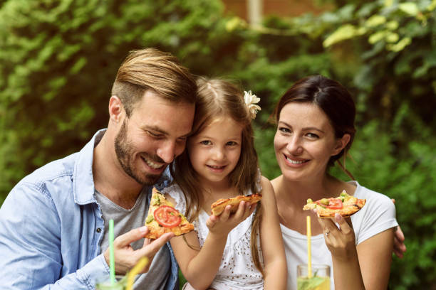 istock Happy family eating in a restaurant 804619768