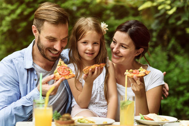 istock Happy family eating in a restaurant 804619800